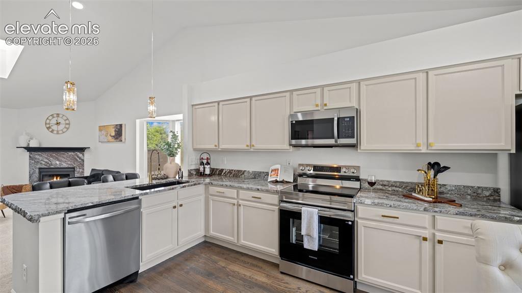 Image 9 of 46: Kitchen featuring light-toned cabinetry, stainless steel appliances, and st