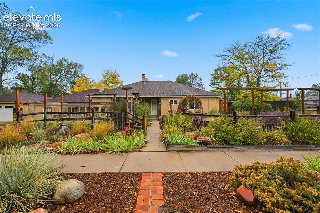 Image 1 of 50: The front of the home with so many gardens! The main home is on the right a