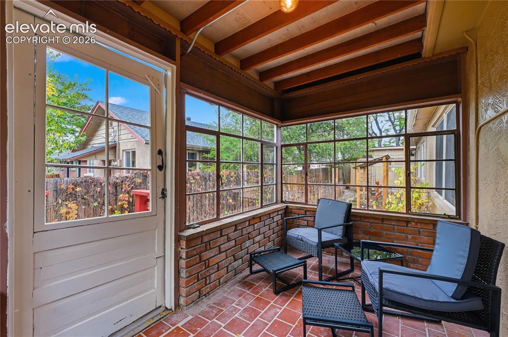 Image 12 of 50: The charming sun room off the back of the kitchen. Another place to enjoy t