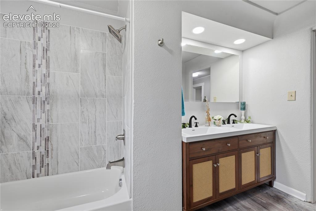 Image 20 of 50: A newly remodeled full bathroom with custom tile.