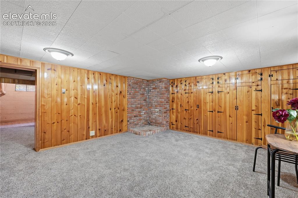 Image 28 of 50: The family room in the basement. Lots of space and even more storage closet