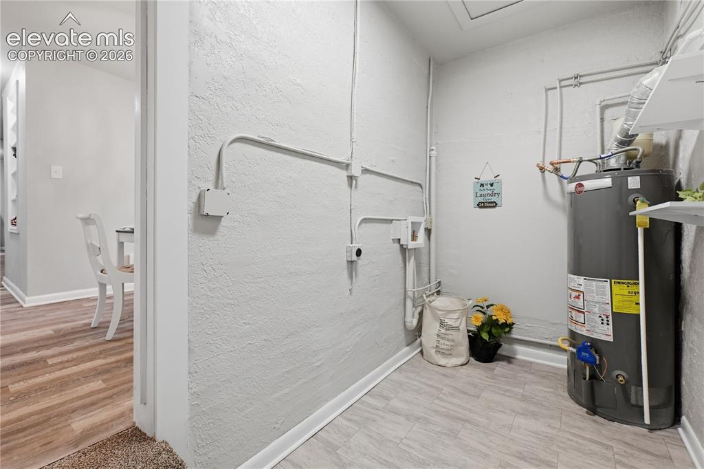Image 29 of 50: The laundry room separates the 2 living spaces. It can be shared or totally