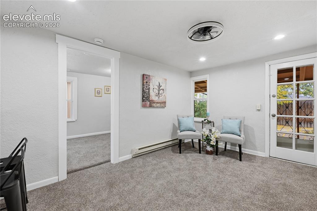 Image 31 of 50: Another view of the great room in the apartment portion. The back door lead