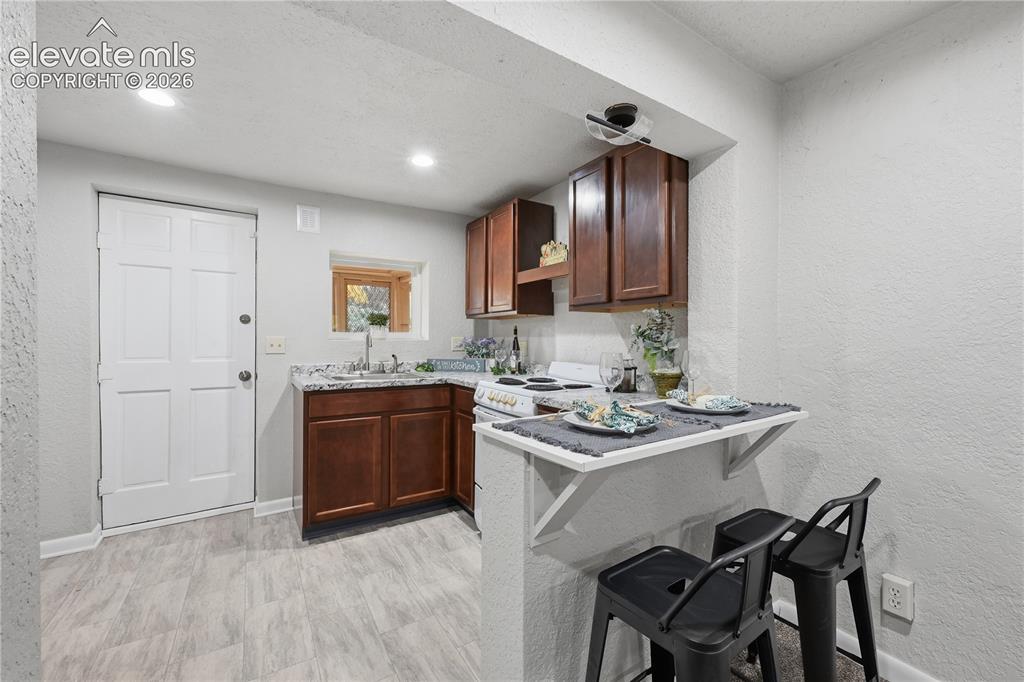 Image 32 of 50: A fully functional kitchen in the apartment. With refrigerator and stove. T