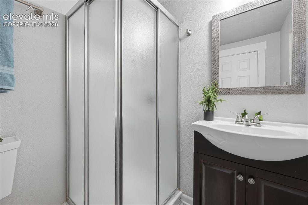 Image 34 of 50: The bathroom in the apartment portion of the home.
