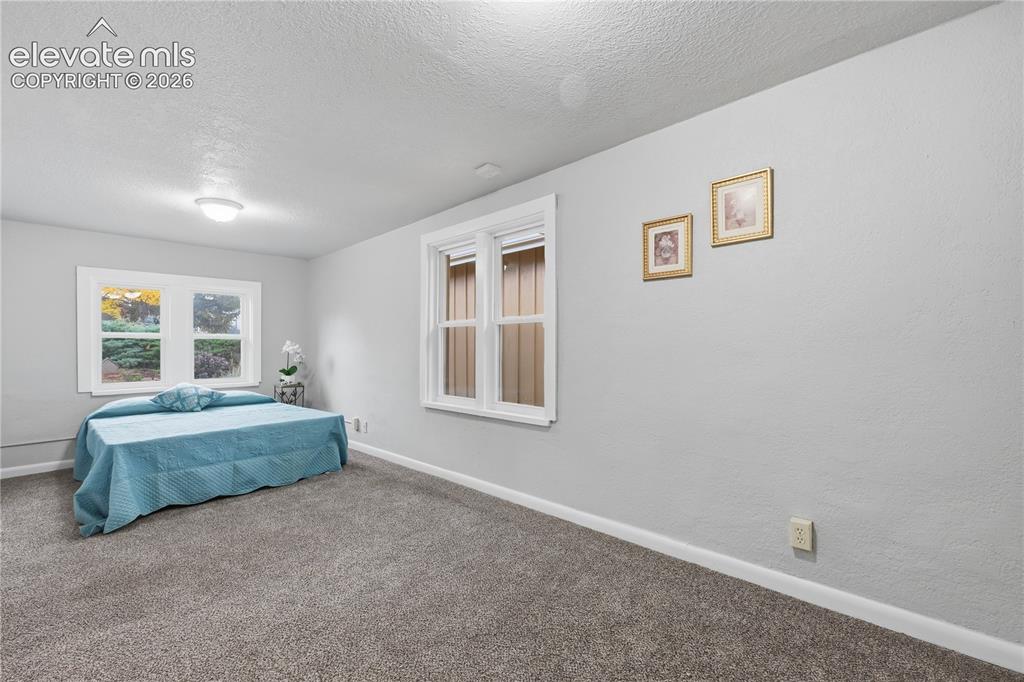 Image 35 of 50: The large bedroom in the apartment portion of the home.