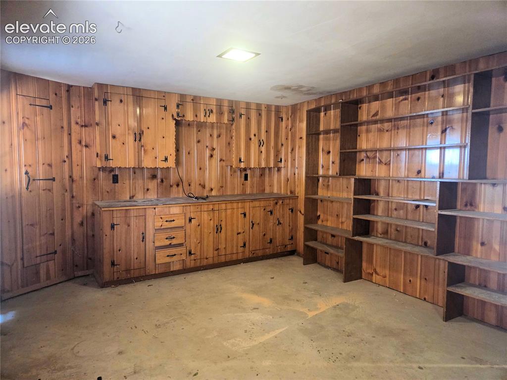 Image 47 of 50: This space can be used for a library, workshop, hobby room, office or all k