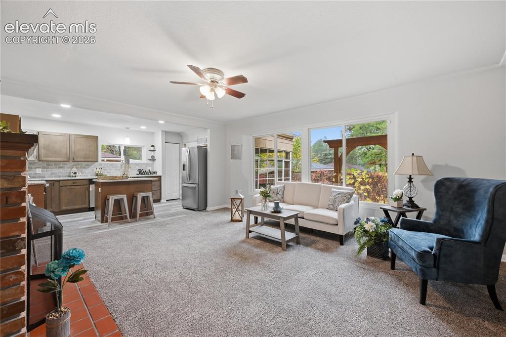 Image 5 of 50: The large living room with huge windows allow you to enjoy your gardens.