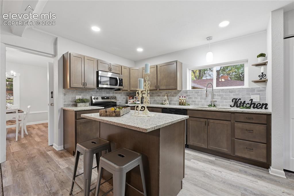 Image 8 of 50: A fully remodeled kitchen! All new cabinets, slab granite countertops and a