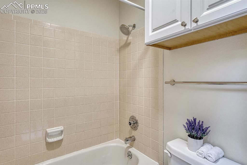 Image 24 of 50: Full bath with toilet and shower / washtub combination