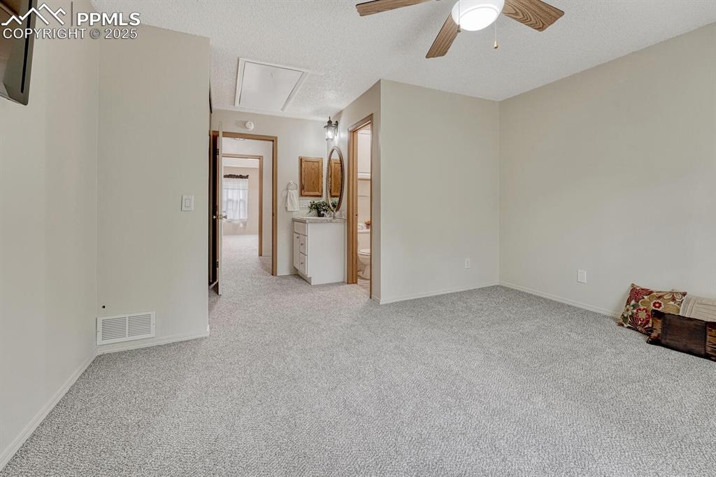 Image 28 of 50: Second bedroom suite includes attached 3/4 bathroom