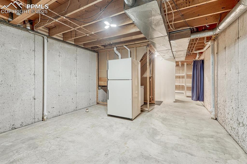 Image 34 of 50: Second basement space is great for storage. Rough-in plumbing makes it poss