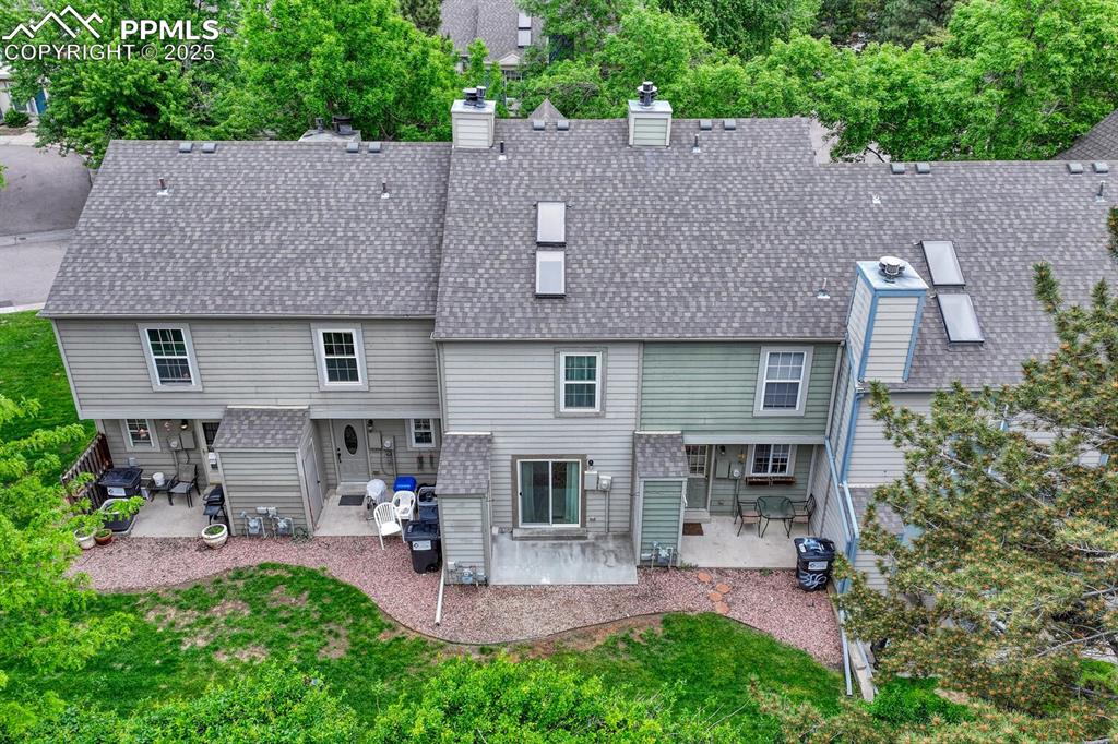 Image 38 of 50: Rear view of property featuring a patio area, roof with shingles, and a chi
