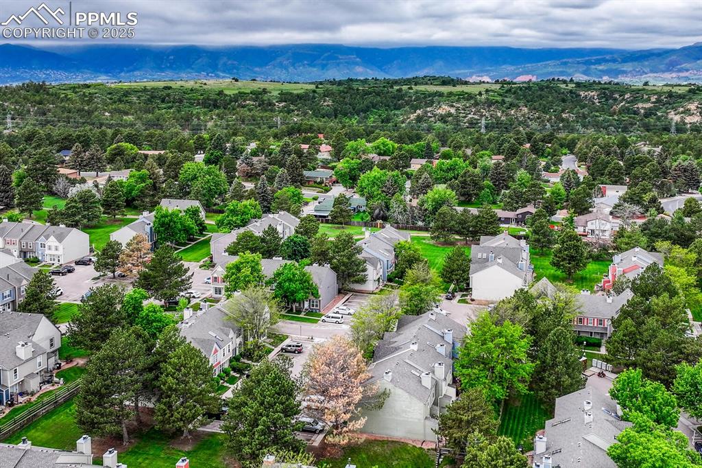 Image 45 of 50: Aerial perspective of suburban area featuring mountains
