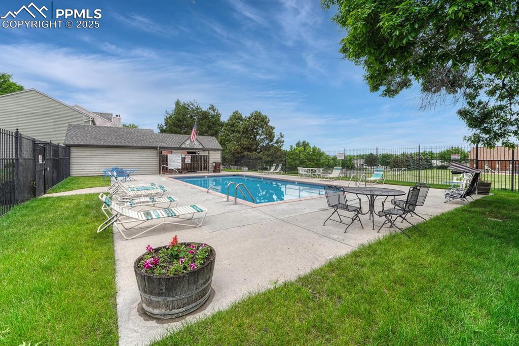 Image 49 of 50: Community pool with a patio