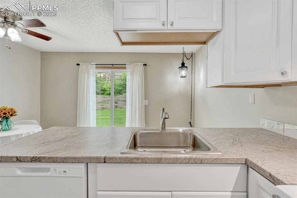 Image 8 of 50: Kitchen overlooks the dining area and back yard