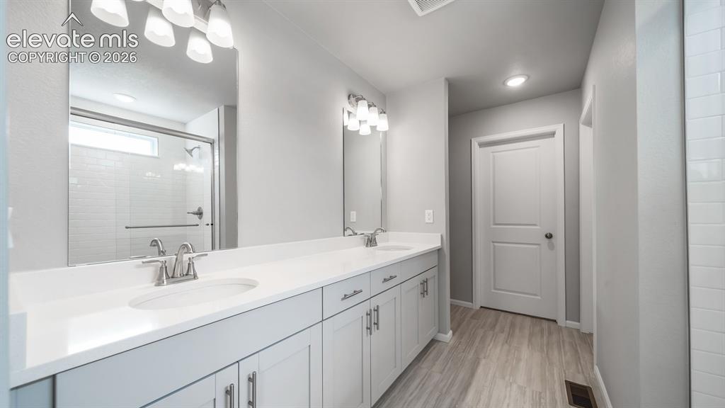 Image 22 of 34: Double vanity with white countertops and light gray cabinetry
Photos of a