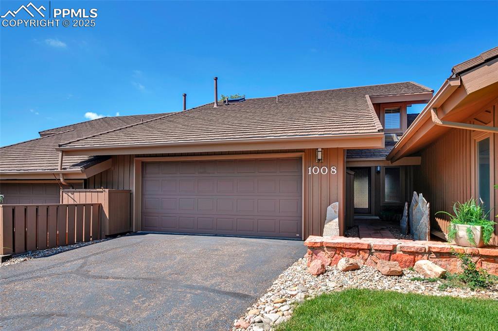 Caption: View of front of house featuring an expanded two-car, heated garage.