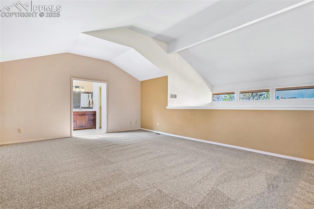 Image 13 of 25: Grand loft bedroom or upper primary suite includes: sitting area, dual cus