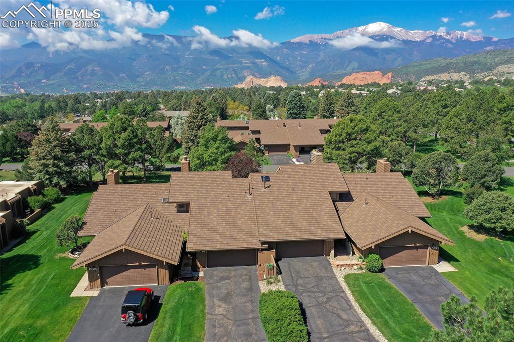 Image 20 of 25: View from above of property with a mountainous background