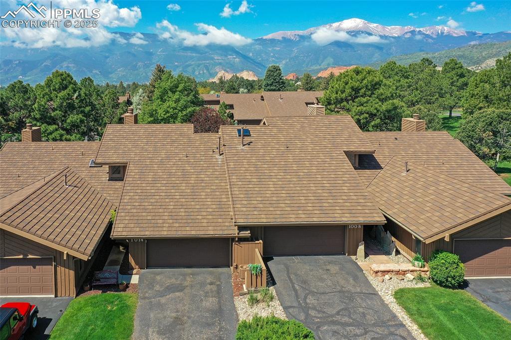 Image 25 of 25: View of front of house featuring a chimney, a mountain view, and board and