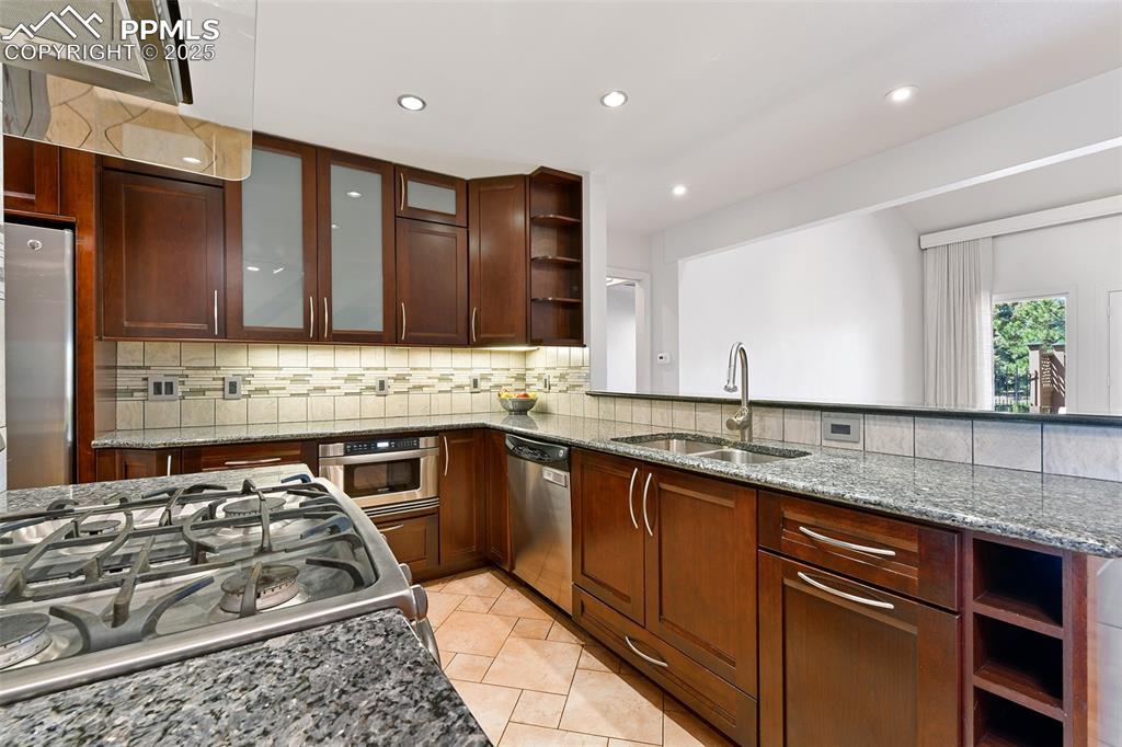 Image 6 of 25: Sassy yet sophisticated kitchen features: custom cabinetry, stainless stee
