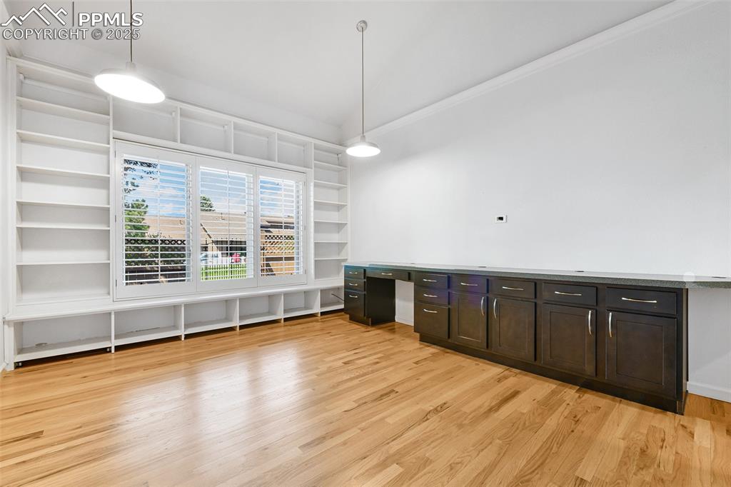 Image 9 of 25: Main level bedroom features: lovely hardwood flooring, built-ins, walk-in