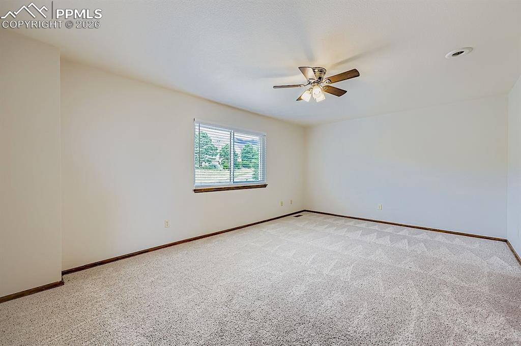 Image 24 of 48: Carpeted empty room featuring baseboards and a ceiling fan