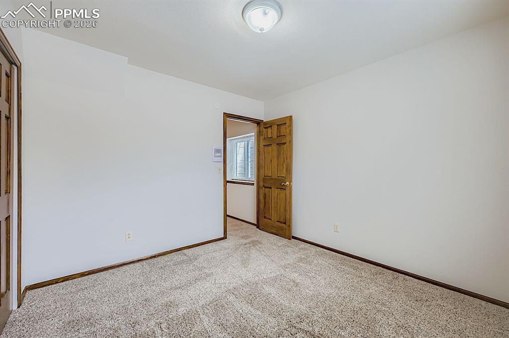 Image 37 of 48: Carpeted spare room with baseboards