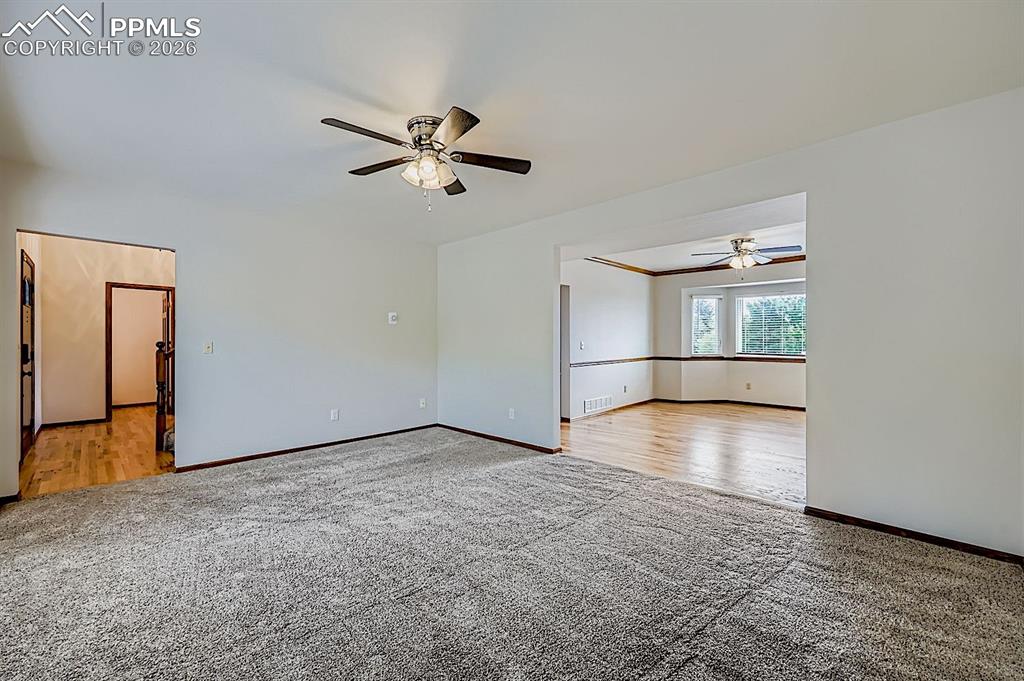 Image 9 of 48: Spare room with light carpet and a ceiling fan