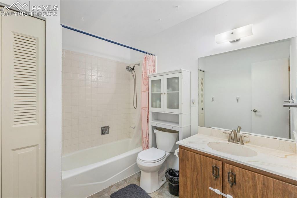 Image 11 of 32: Full bath featuring shower / bathtub combination with curtain, vanity, and 