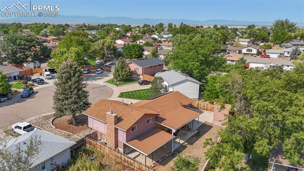 Image 32 of 32: Aerial view of residential area with a mountainous background