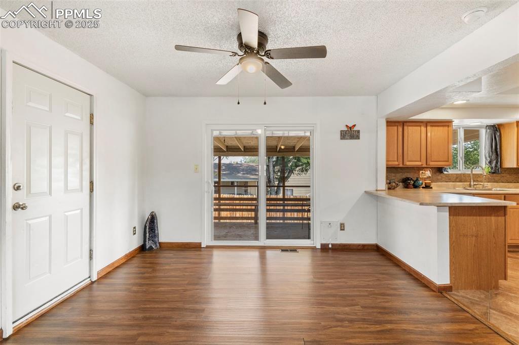 Image 6 of 32: Kitchen featuring light countertops, dark wood finished floors, a peninsula