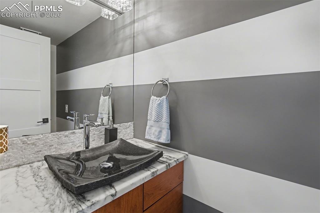 Image 13 of 50: Main level half bathroom