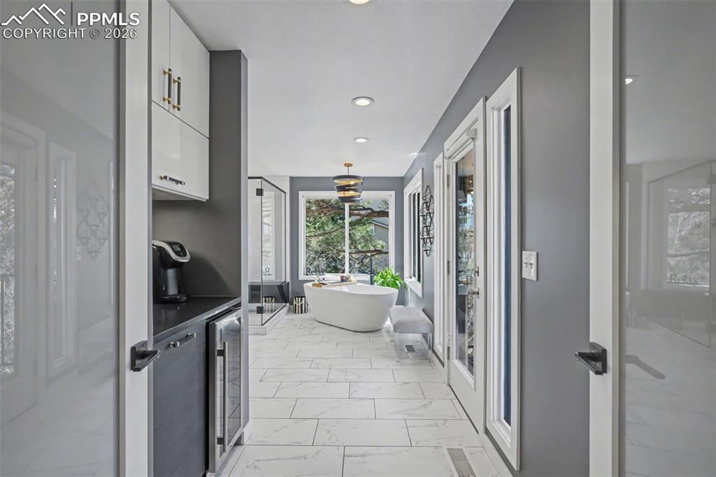 Image 27 of 50: Primary Bathroom with coffee bar and walk out to expansive deck
