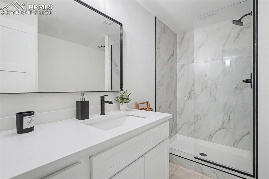 Image 35 of 50: modern remodeled basement bathroom