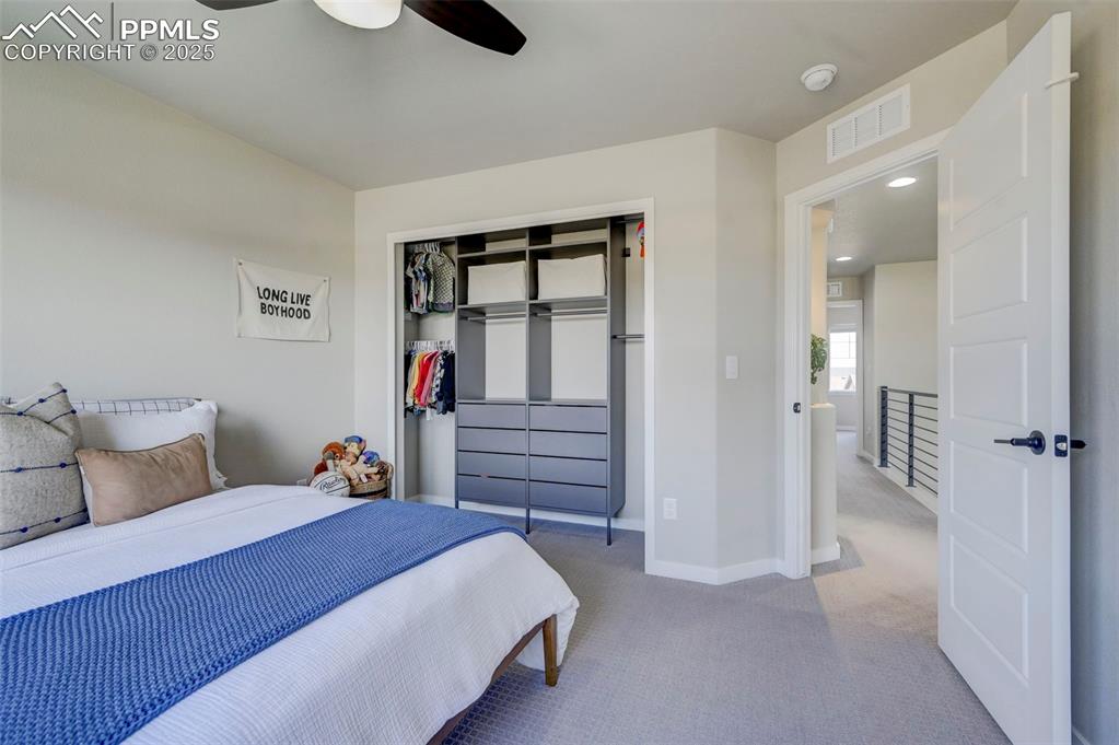 Image 24 of 50: Bedroom with light carpet, a closet, ceiling fan, and recessed lighting