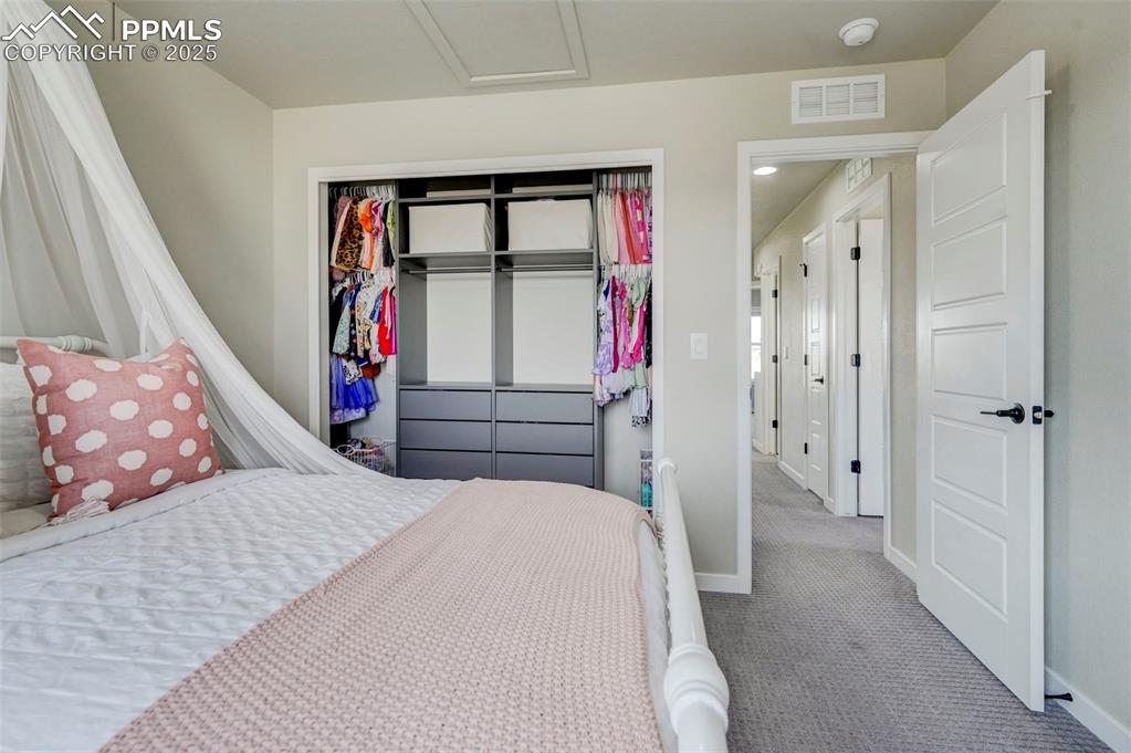 Image 29 of 50: Carpeted bedroom with baseboards and a closet