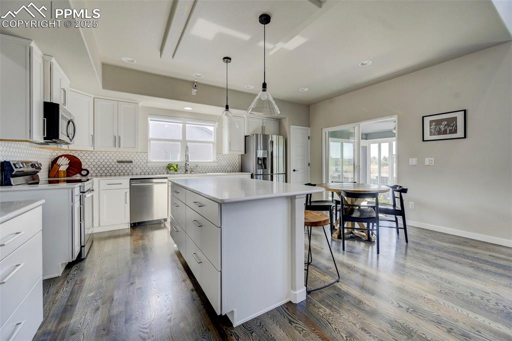 Image 33 of 50: Kitchen featuring appliances with stainless steel finishes, white cabinetry