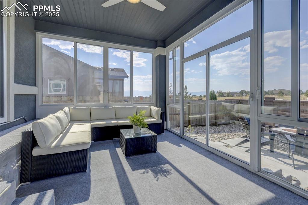 Image 46 of 50: Sunroom / solarium with ceiling fan, carpet, and an outdoor living space
