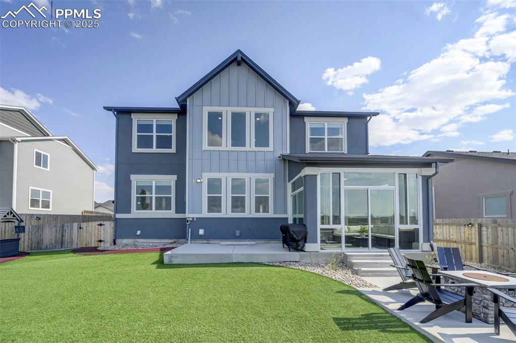 Image 48 of 50: Rear view of property featuring a sunroom, a fenced backyard, a patio, and