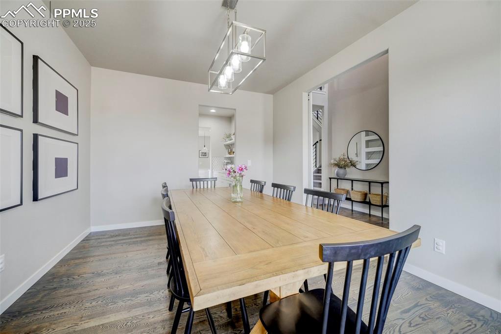Image 5 of 50: Dining space featuring wood finished floors and baseboards