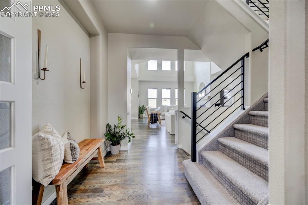 Image 7 of 50: Foyer with wood finished floors and stairs