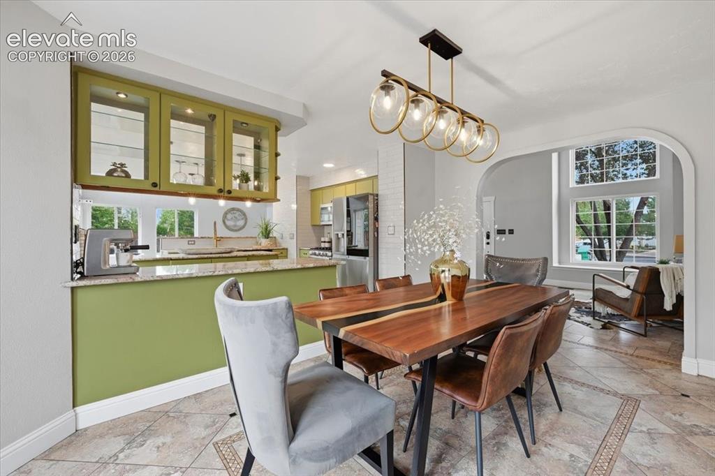 Image 11 of 50: Stylish dining rom with upgraded lighting!