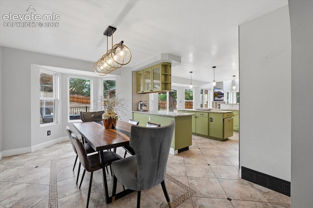 Image 13 of 50: Dining room opens to the remodeled kitchen!