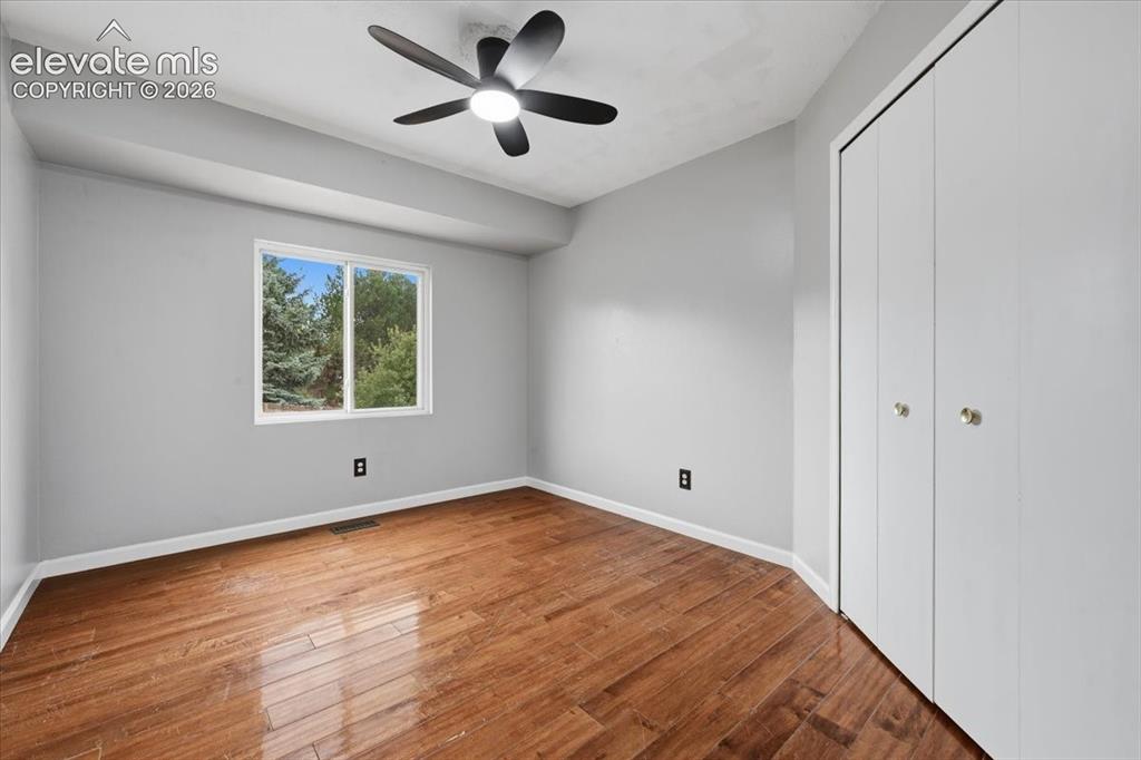 Image 26 of 50: Second upstairs bedroom with engineered hardwood flooring!