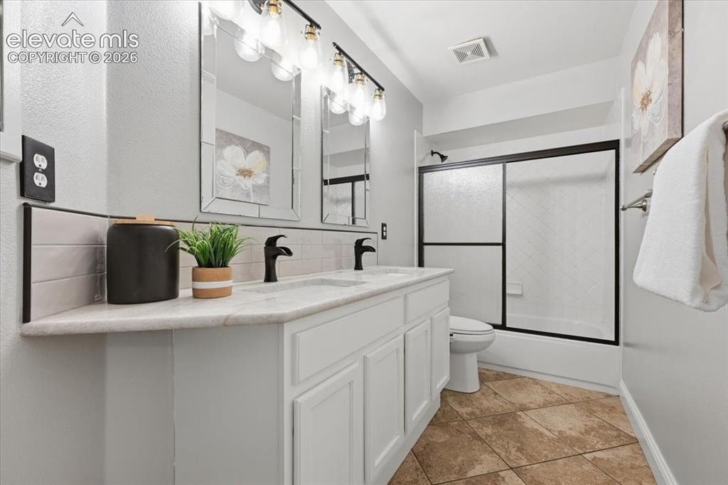 Image 28 of 50: Upstairs hall bath with new lighting, granite counters and upgraded faucets