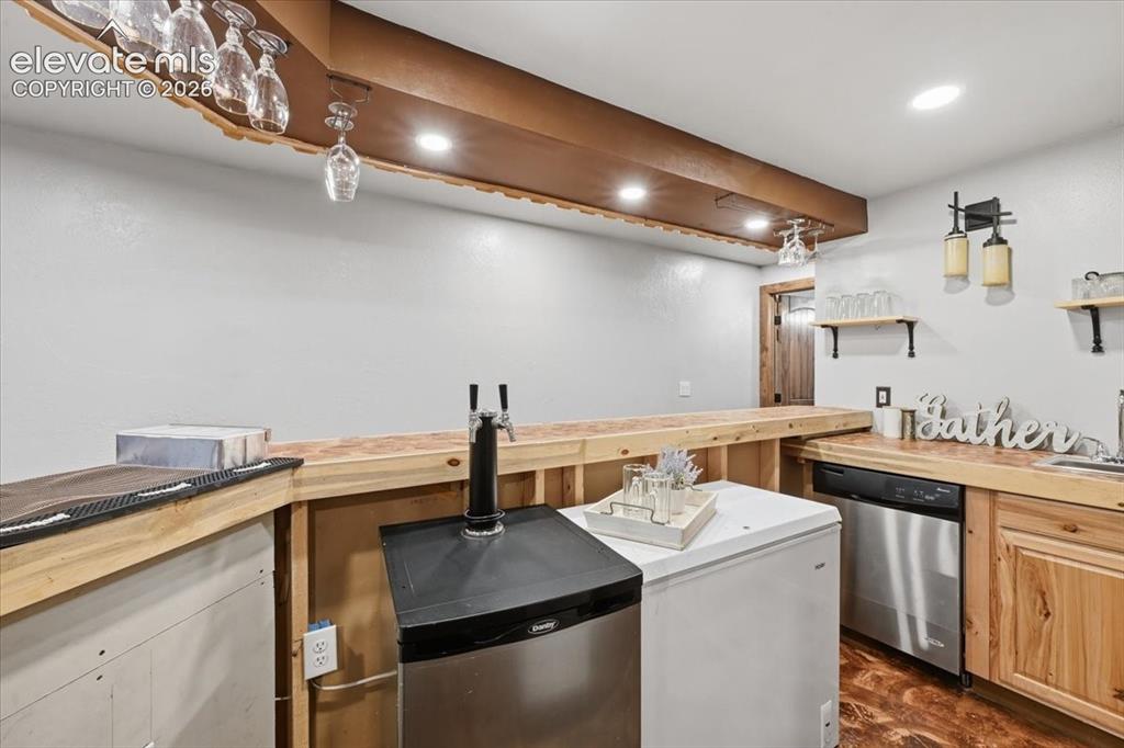 Image 35 of 50: Wet bar with dish washer, wine glass storage and open shelves!!
