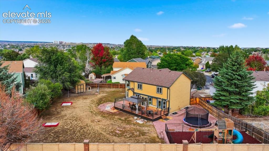 Image 4 of 50: Wonderful back yard with play structure, huge new deck and shed!