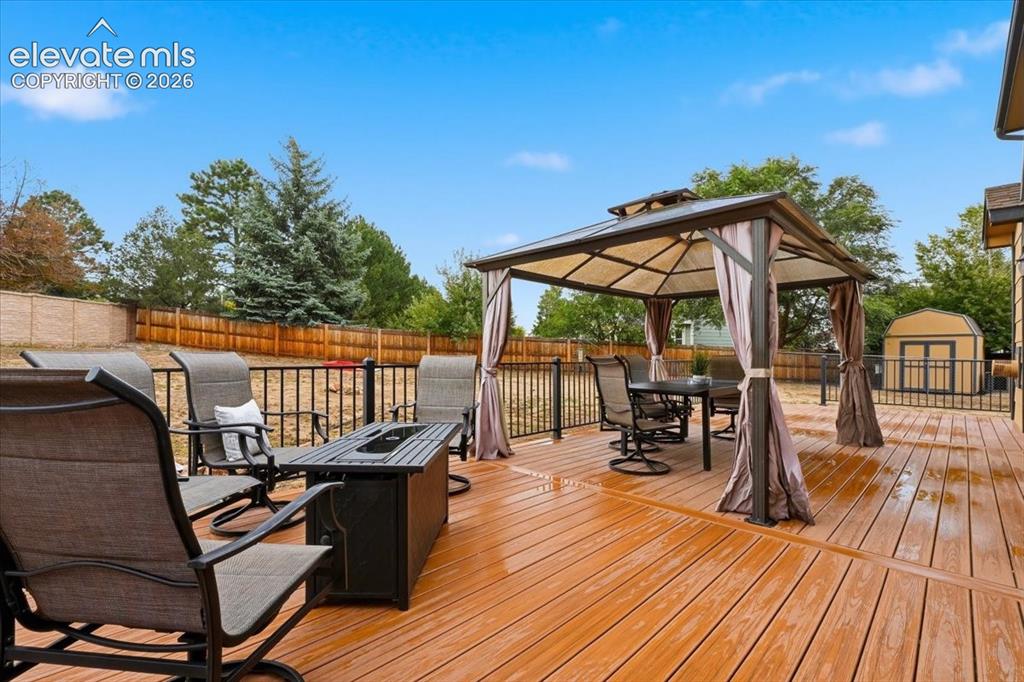 Image 44 of 50: Wrought iron rails, included pergola and shed!